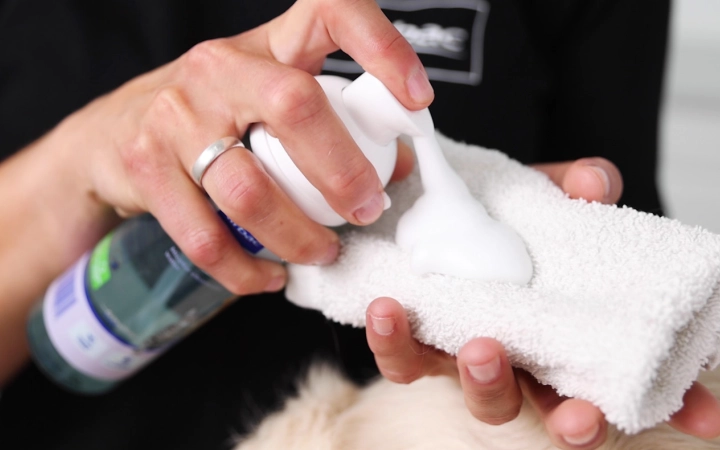 Hand holding the cloth and Allerderm Foam